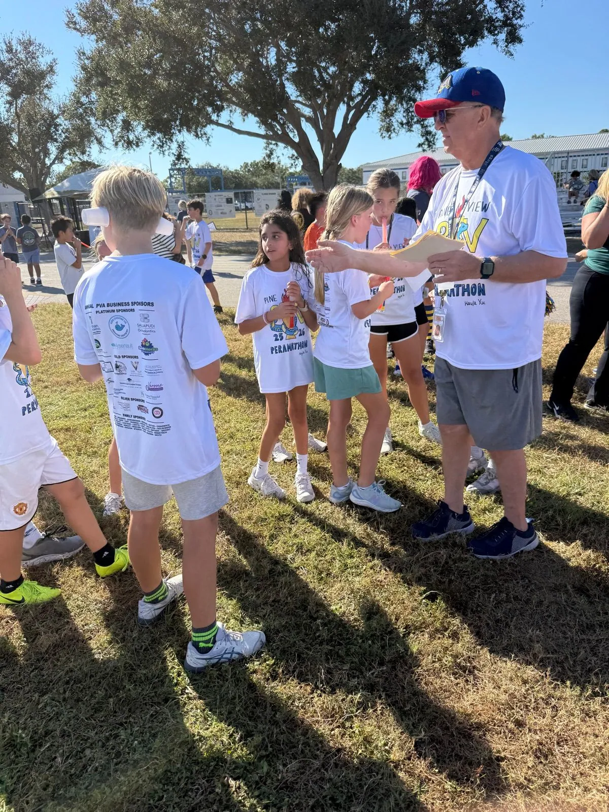 Students running, grade-level competitions, volunteers, cheering