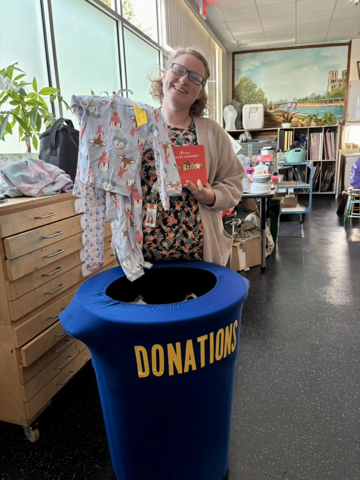 A volunteer with the donations bin